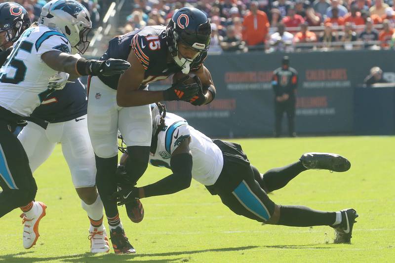 Chicago Bears wide receiver Rome Odunze gets out of a tackle by Carolina Panthers safety Xavier Woods and teammate cornerback Jace Horn on Sunday, Oct. 6, 2024 at Soldier Field in Chicago.