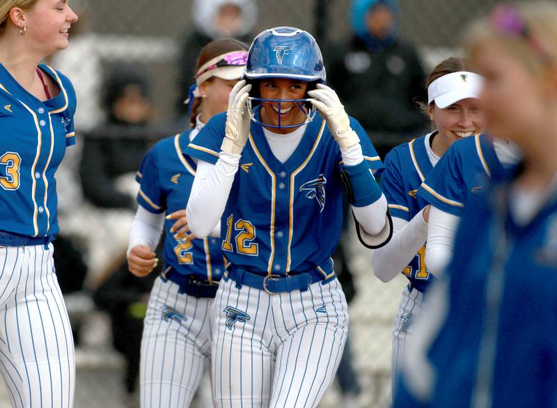 Wheaton North's Abby Del Preto (center) celebrates with her team after scoring a home run during a game against St. Charles North on Tuesday, April 15, 2025 in St. Charles.