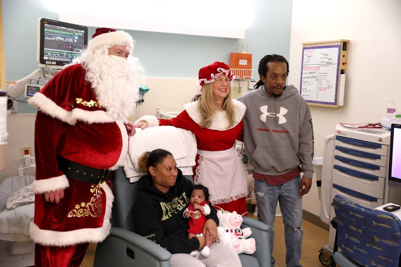 Tyler and Elizabeth McClarty of Batavia and their newborn daughter, Mya, get a visit from Santa and Mrs. Claus in the NICU at Northwestern Medicine Central DuPage Hospital in Winfield on Wednesday, Dec. 20, 2023.