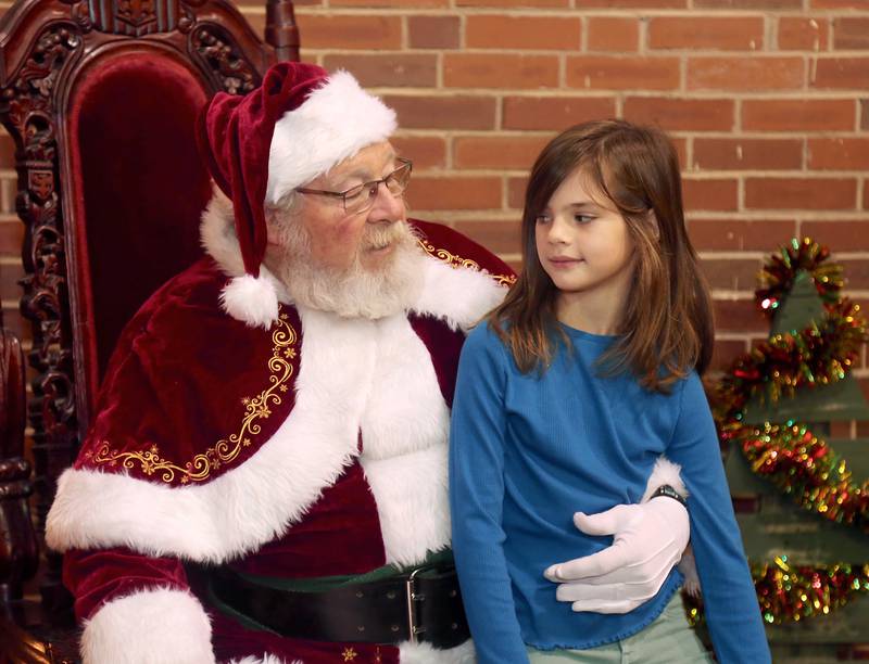Santa chats with Olivia Michaels, 7, of Elburn