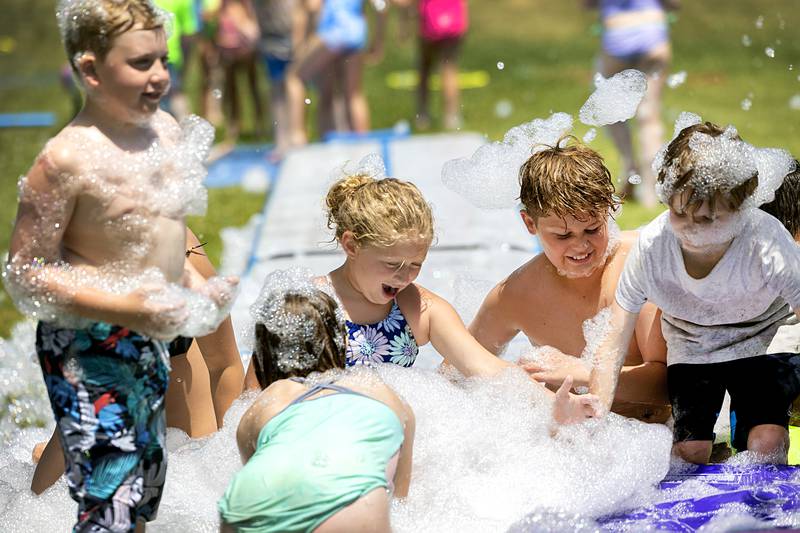 Campers get down and sudsy Tuesday, June 18, 2024, during Dixon Park District’s SPARK Camp. For two days campers could enjoy all sorts of water activities and sporting events at the district’s Facility.