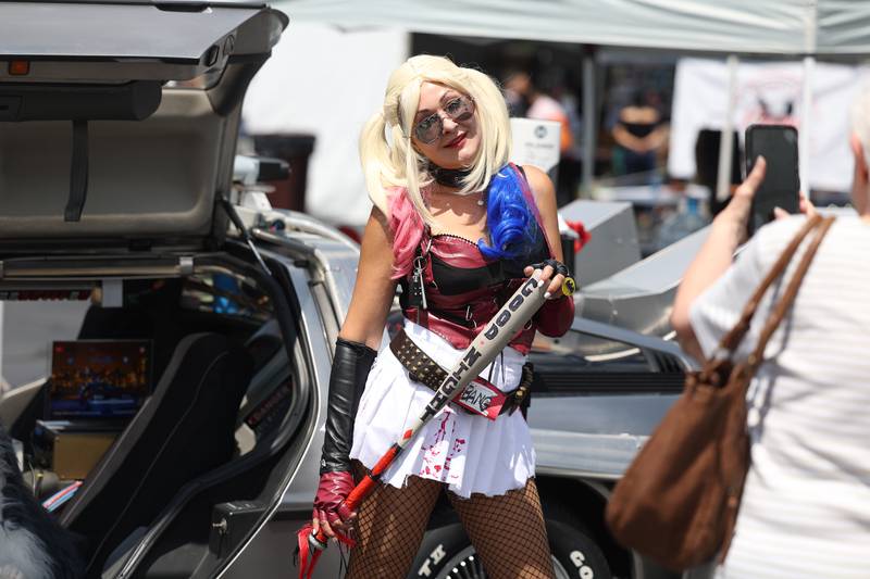 Cindy Bumber, dressed as Harley Quinn from the DC Batman comics, poses for a photo at the Back to the Future DeLorean at Comicolopis, Lockport’s 7th annual Comic and Fandom Con on Saturday, July 29.