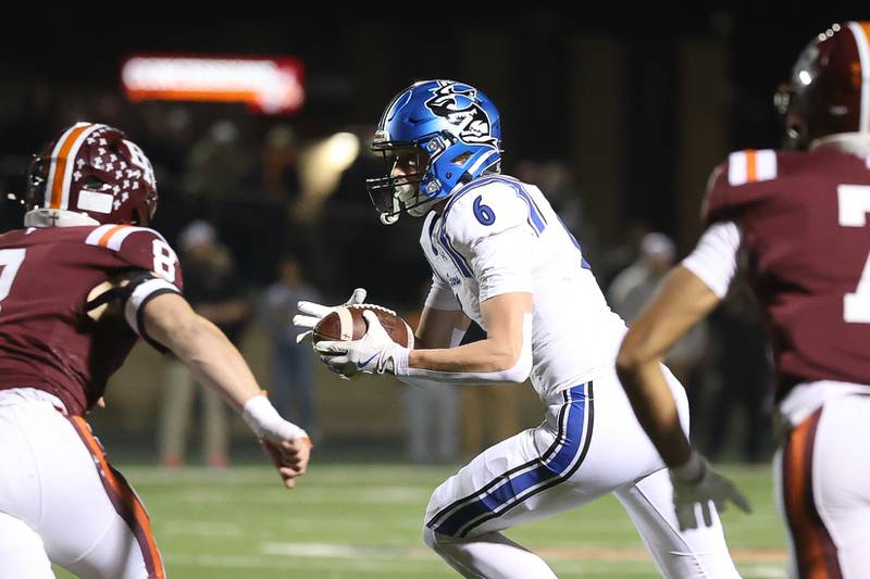 St. Charles North's Keaton Reinke takes a pass up field against Brother Rice in the third round of the playoffs on Saturday, Nov. 15, 2025 in Chicago.