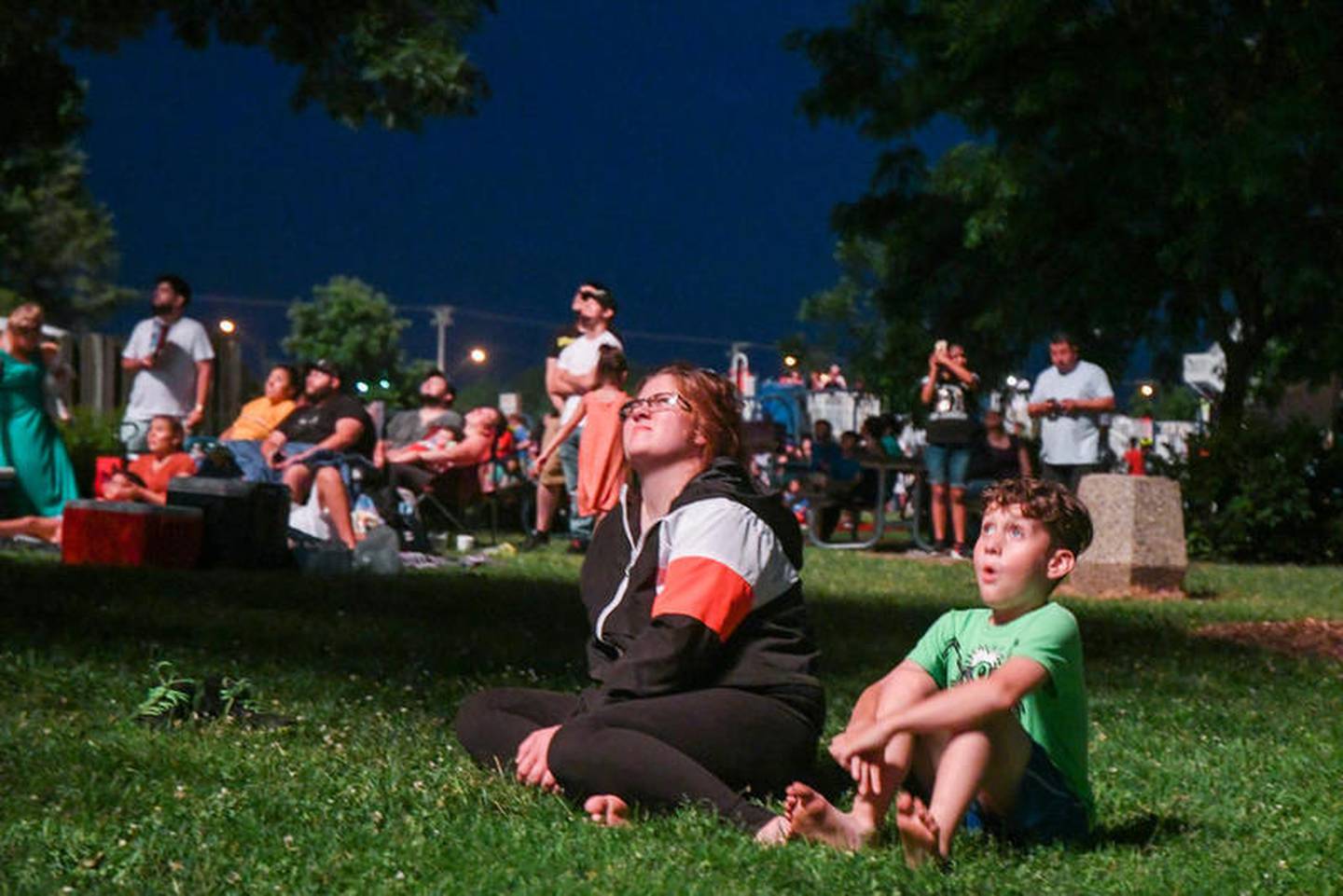 Vincent and his mom Kelly Tan of DeKalb watch the fireworks at Hopkins Park during the July Fourth festivities and fireworks.