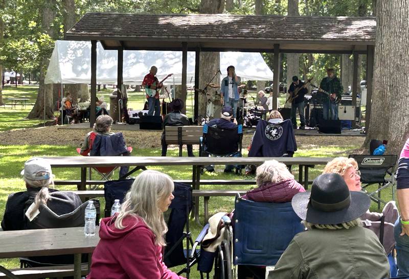 People listen to one of the bands that performed during Fest by the Nest at Lowden State Park on Saturday, Sept. 6, 2025. The event was organized by Together for Taft, a nonprofit, to raise funds and awareness of an effort to reopen the Lorado Taft Field Campus that was shuttered by Northern Illinois University in December 2024.
