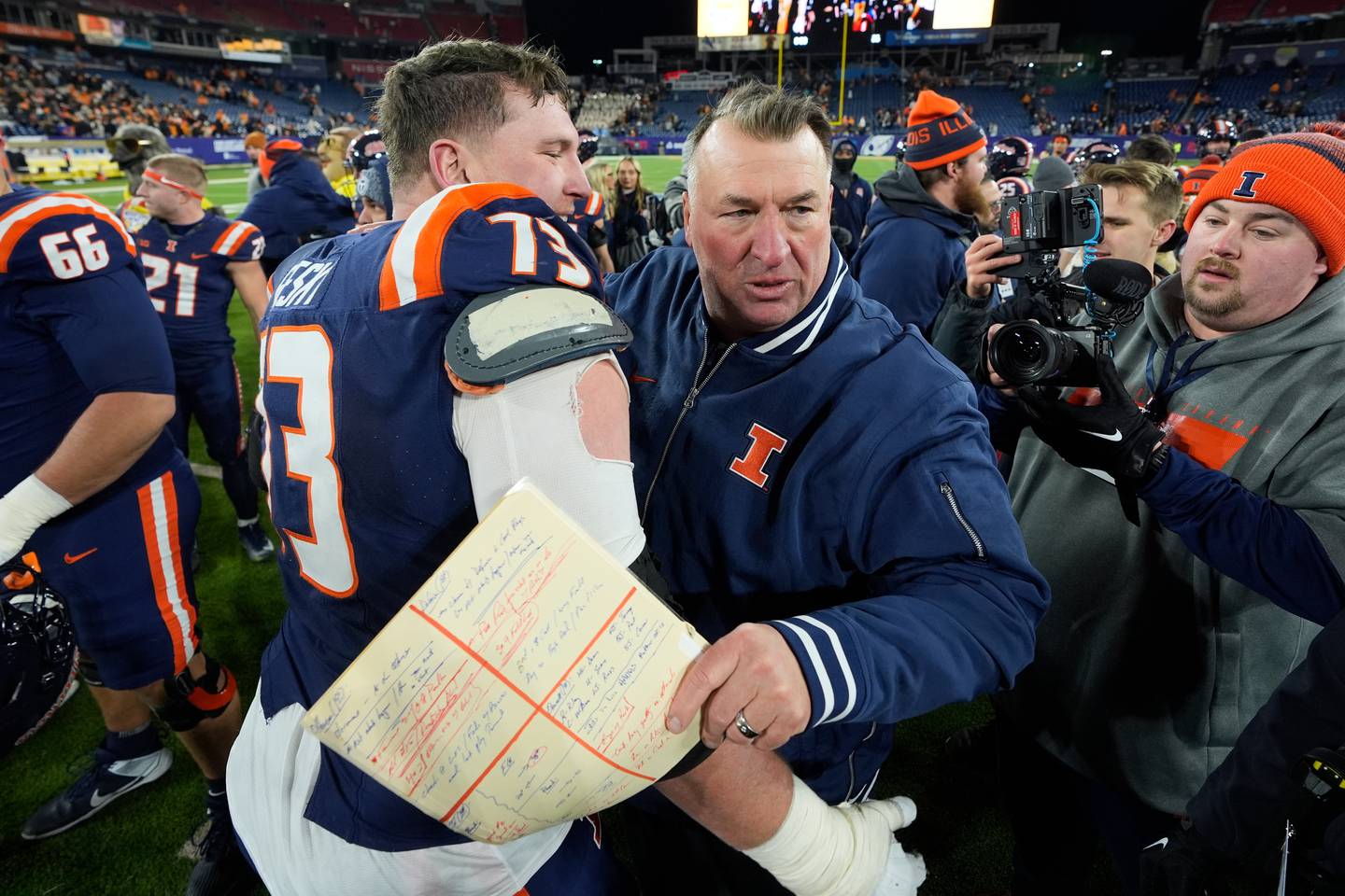 Illinois offensive lineman Josh Gesky (73) celebrates with head coach Bret Bielema, right after winning the Music City Bowl NCAA college football game against Tennessee, Tuesday, Dec. 30, 2025, in Nashville, Tenn. (AP Photo/George Walker IV)