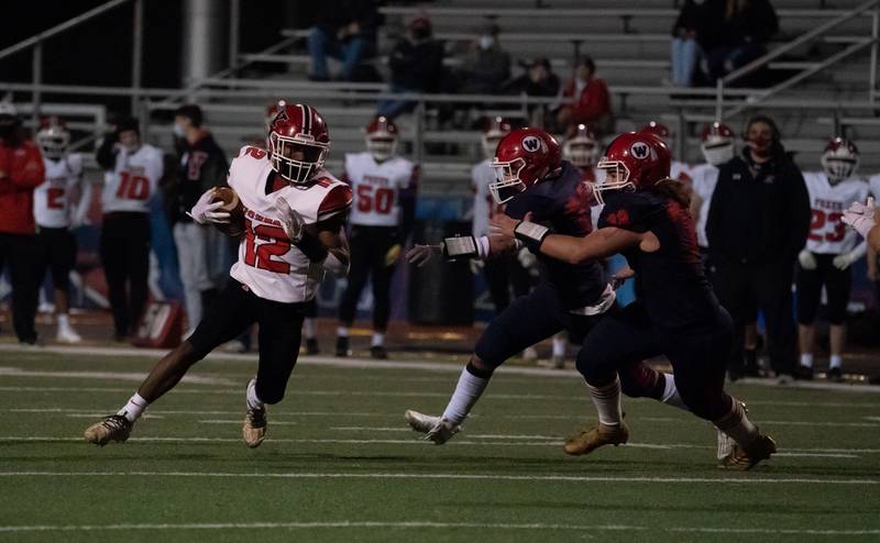 Yorkville's John Swarn (12) runs after the catch against West Aurora during a football game in Aurora March 26