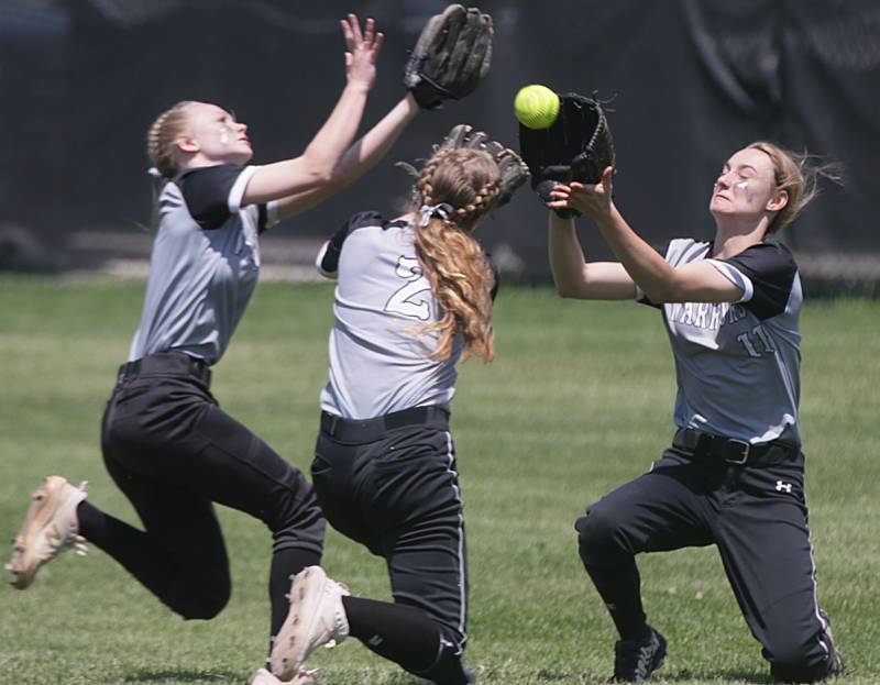 Woodland/Flanagan-Cornell's Cloee Johnston (far right) makes the catch as WFC teammates Olivia Chismarick and Ella Derossett (2) converge on the ball during the 2022 Class 1A Dwight Sectional championship game.
