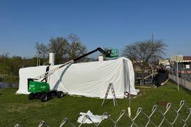Geneva blacksmith shop shrink-wrap flap persists; city cites developer over plastic cover