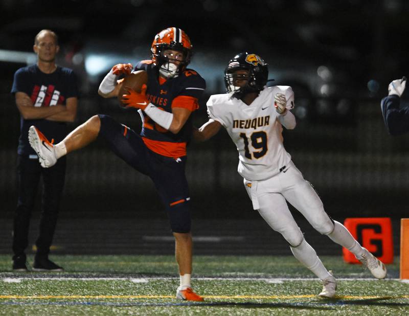 Naperville North’s Zachary Mally, left, intercepts a pass in front of Neuqua Valley’s Daniel Robinson during a football game played on Friday, Oct. 11, 2024 in Naperville.