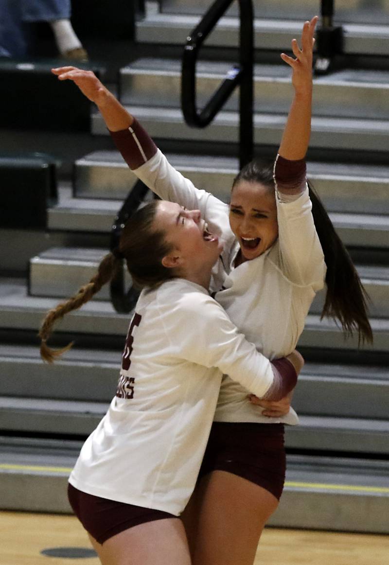 Prairie Ridge's Kate Hartmann-Starkey hugs her teammate, Maizy Agnello, after they defeated Crystal Lake South in the IHSA Class 3A Crystal Lake South Sectional final volleyball match on Thursday, Nov. 7, 2024, at Crystal Lake South High School.