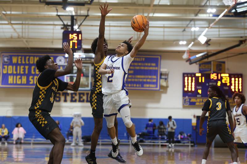 Joliet Central’s Kaden Henry lays in the contested shot against Joliet West on Thursday, Jan. 15, 2026 in Joliet.