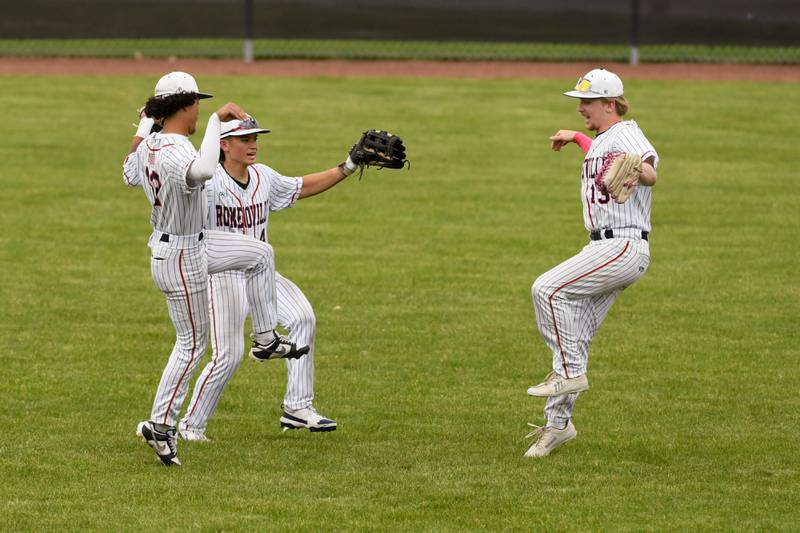 Romeoville teammates Richard Conley, left, Nolan Holgado, center, and Romeoville's Nicholas Whitford (13) all celebrate their regional game victory after defeating Yorkville on Thursday May 29, 2025, held at Yorkville High School.