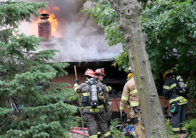 Flames pour out of the roof of a home in the 500 block of North 2782nd Road on Monday, July 21, 2025 in La Salle. FIre departments from Utica, Wallace, Naplate, Spring Valley, Mendota, Troy Grove, La Salle, Peru, Oglesby and Tonica responded to the scene. Fire crews were dispatched at 9:45 a.m. La Salle Police and La Salle County Sheriff were also on the scene.