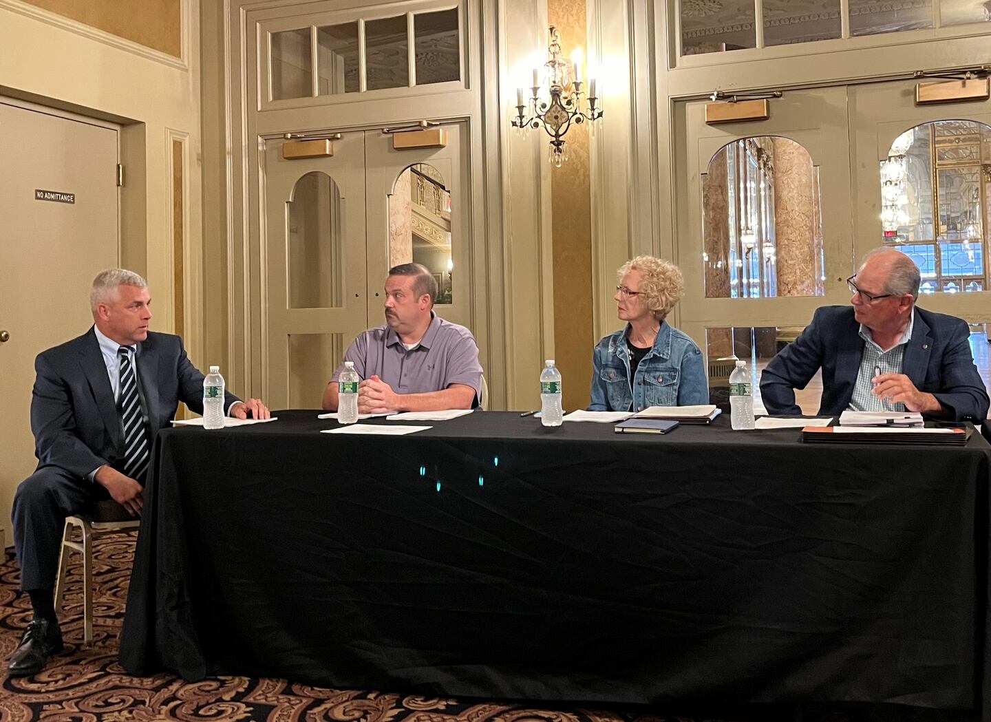 Joliet Mayor Robert O'Dekirk (left) speaks to the board of the Rialto Square Theater on Wednesday, Aug. 24, 2022. Seated next to O'Dekirk are board members William Kent, Jane Condon and Board Chairman Robert Filotto.