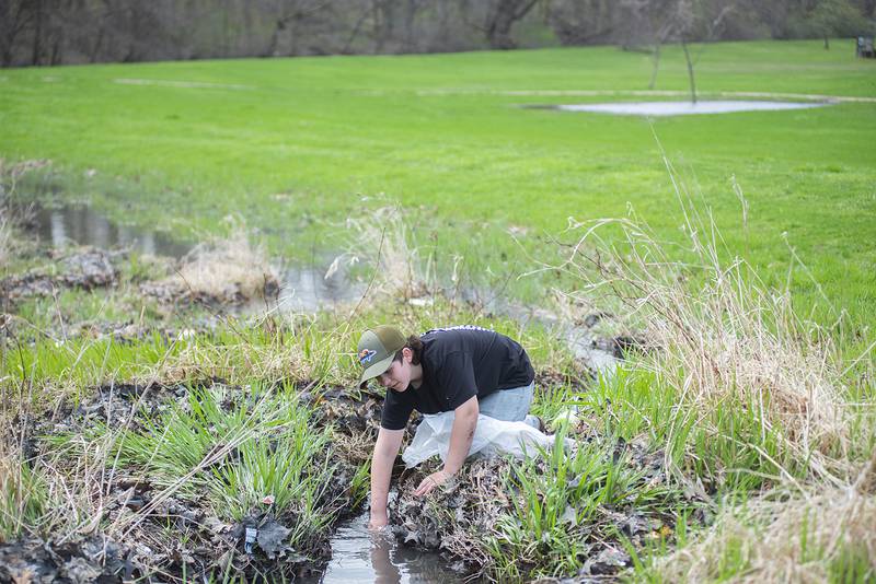 Gabriel Eilers, 12, picks up trash at Centennial Park in Rock Falls on Saturday as part of an Earth Day clean-up event organized by the Rock River Development Authority. The RRDA had more than 50 volunteers hit the canal on Saturday, doing their part to clean up the waterway.