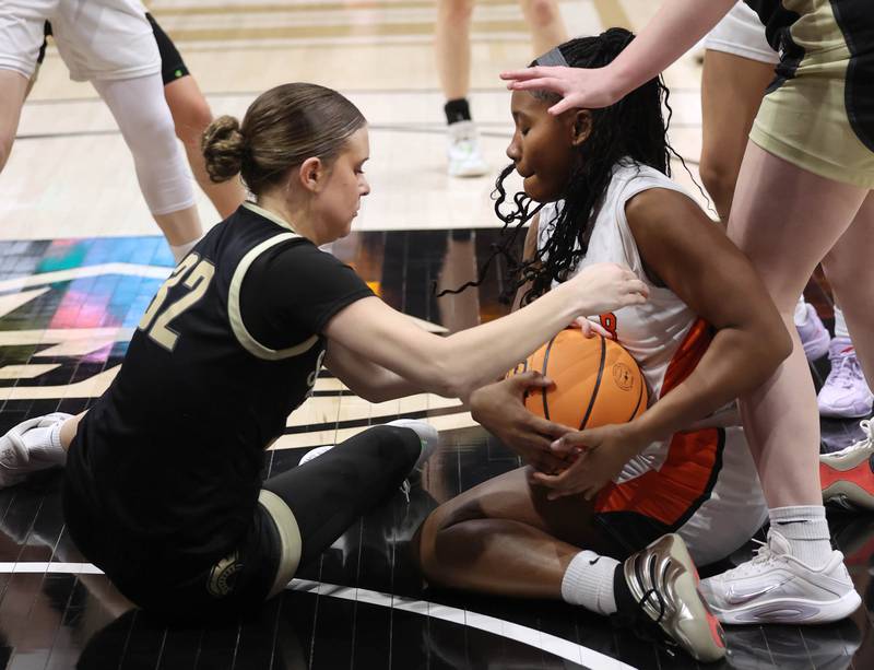 Sycamore's Quinn Carrier (left) and DeKalb's Johnna Patrick fight for a loose ball Friday, Jan. 30, 2026, during their game in the FNBO Challenge in the Convocation Center at Northern Illinois University in DeKalb.