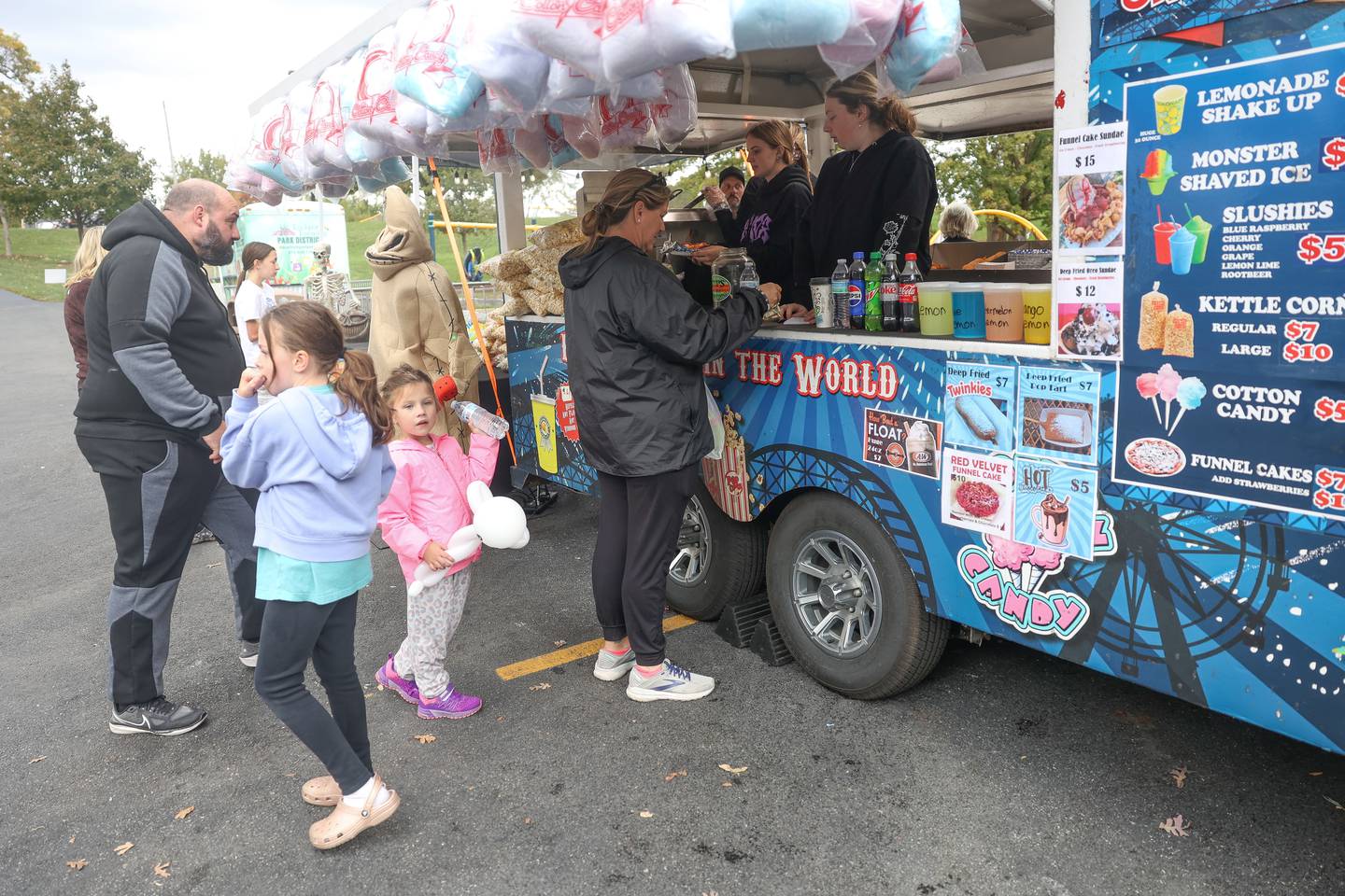 A family orders treats at Mr. Salty’s food truck at the Hayride Horrors on Monday, Oct. 14, 2024 at Dellwood Park in Lockport.