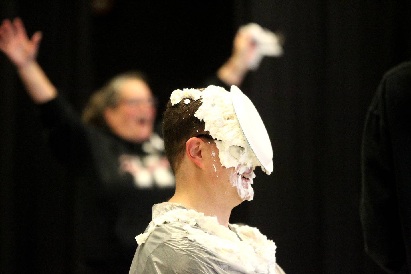 Kaneland Harter Middle School Principal Nathan Schmitt gets a pie of whipped cream in his face as part of the school’s PTO-sponsored Pi Day festivities.