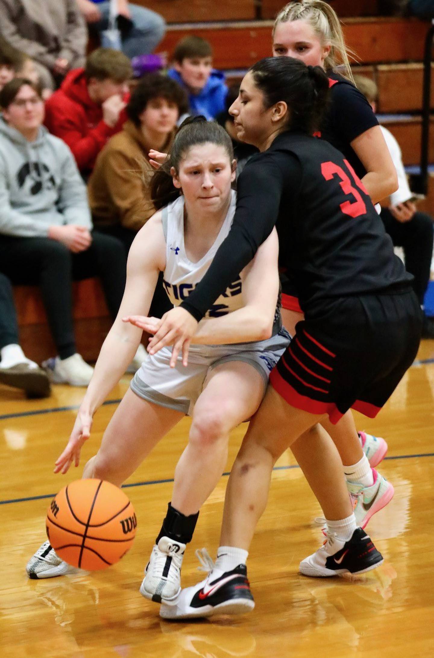 Princeton's Camryn Driscoll drives baseline on Hall's Natalia Zamora in Thursday's game at Prouty Gym. The Tigresses won 34-30.