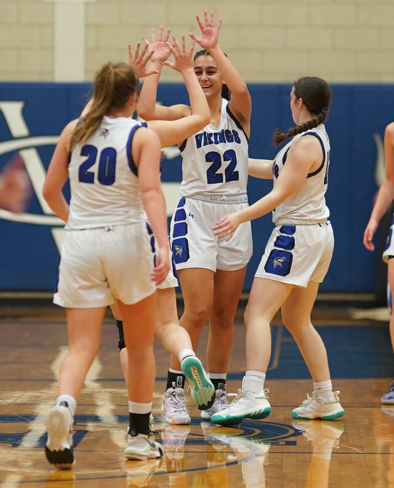 Geneva’s Leah Palmer (22) celebrates with her team after defeating Batavia at Geneva High School on Friday, Dec 15, 2023.