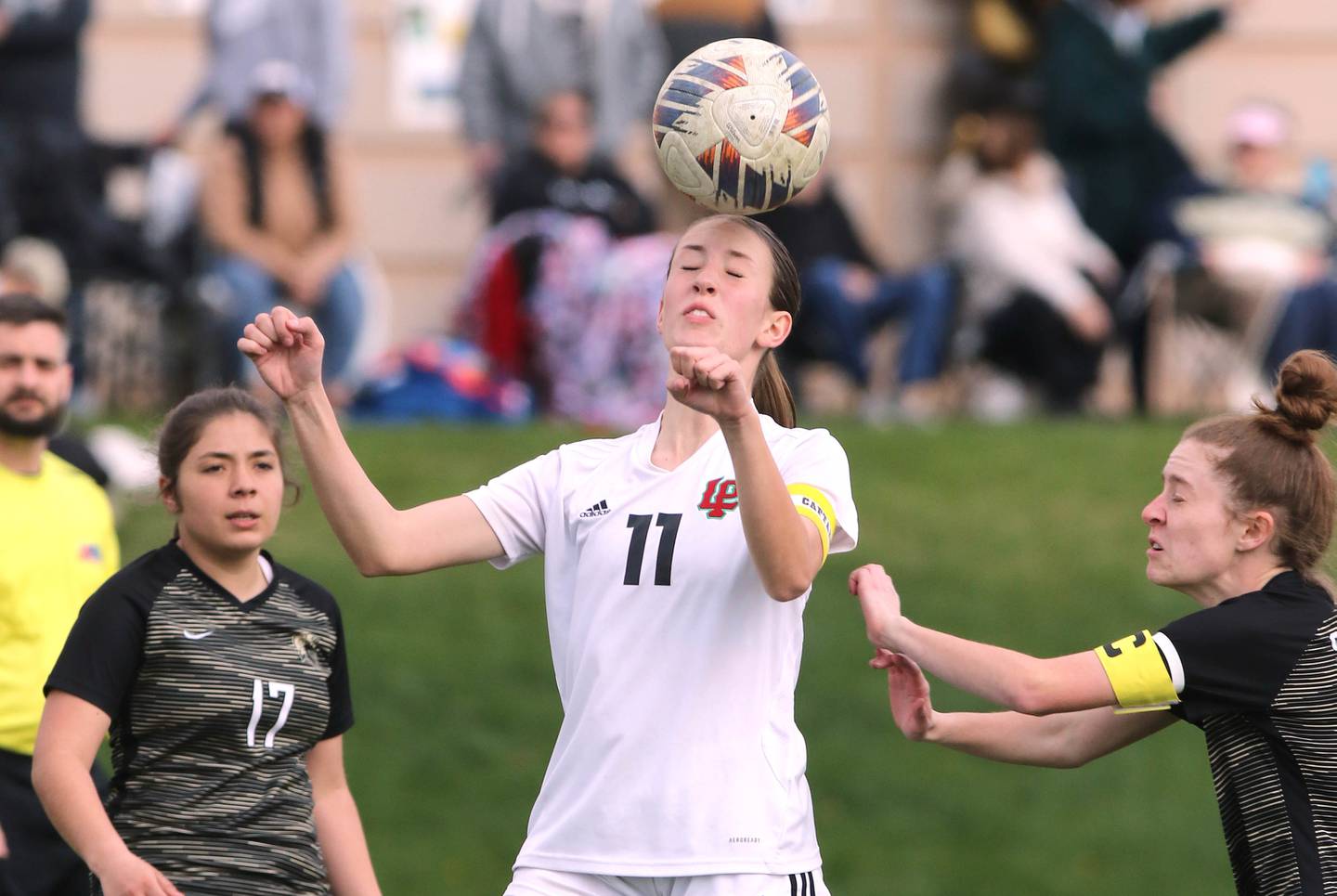 LaSalle-Peru's Danica Scoma heads the ball between two Sycamore players during their game Monday, April 24, 2023, at Sycamore High School.