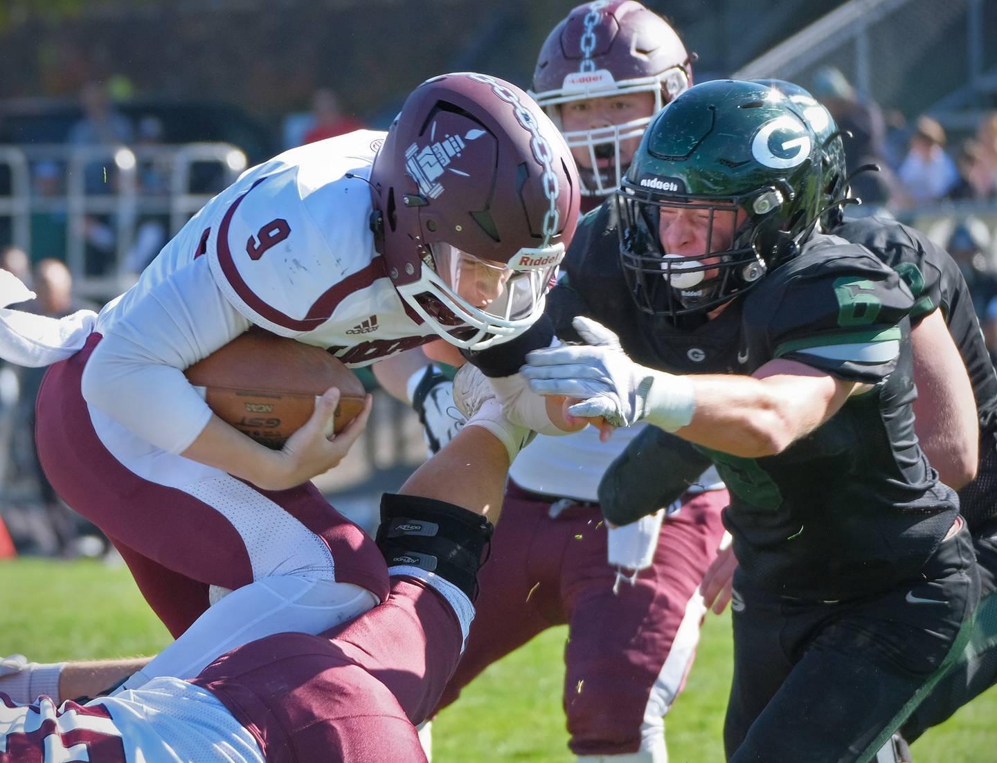 Lockport's Brady Pfeiffer (9) is met by Glenbard West's Ben Starmann (right) as he goes over the top during an IHSA Class 8A playoff game on Oct. 29, 2022 at Glenbard West High School in Glen Ellyn.