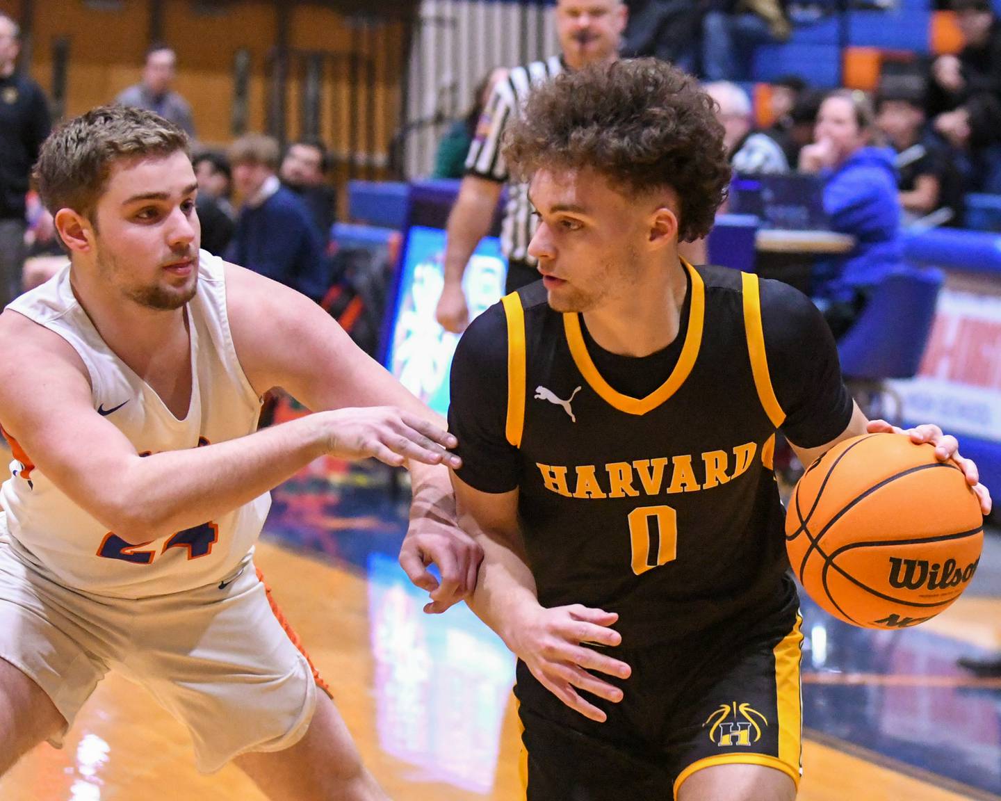 Harvard's Adam Cooke, right, tries to get around Genoa-Kingston's Peyton Meyer (24) during the game on Thursday Feb. 13, 2025, held at Genoa-Kingston High School.