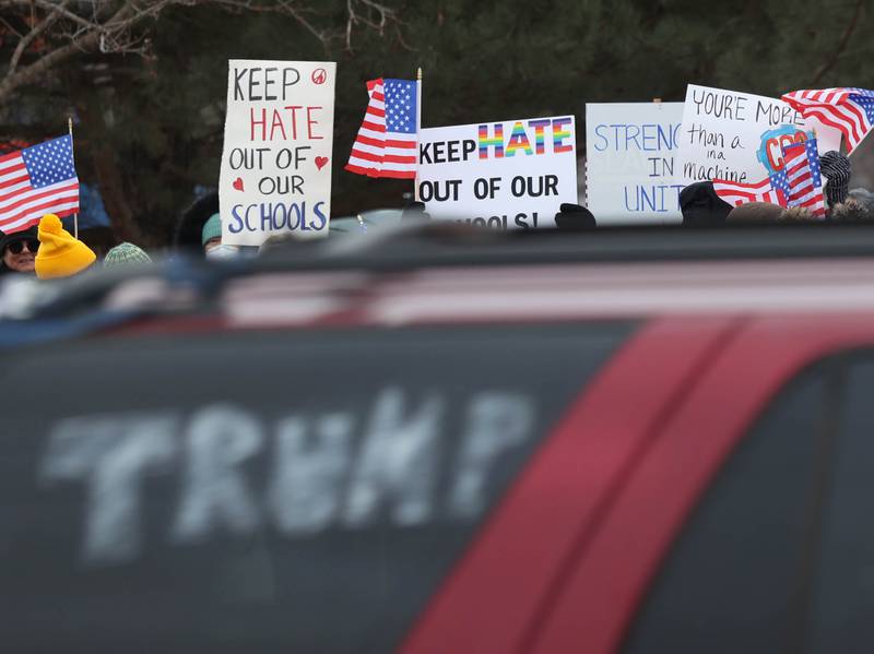 A supporter of President Donald Trump drives by protesters Thursday, Feb. 5, 2026, in front of Genoa-Kingston High School. The group is protesting the “History Rocks” assembly which is part of a nationwide campaign by the U.S Department of Education tied to the nation’s 250th anniversary and organized by the high school’s Turning Point USA, Club America chapter, a nonprofit founded in 2012 by the late Charlie Kirk.