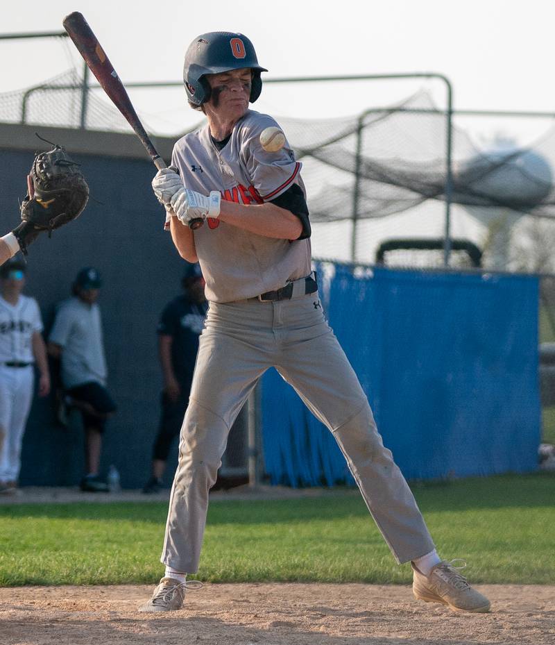 Oswego East's Eric Lewis (2) is hit by a pitch during a baseball game against Oswego at Oswego East High School on Tuesday, May 10, 2022.