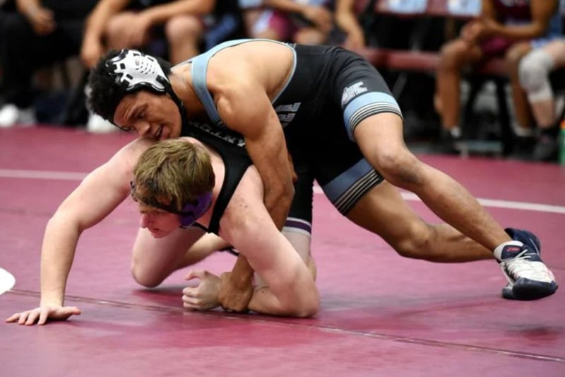 Kankakee's Marquan Riley, top, and Manteno's Connor Harrod grapple during Wednesday's All-City meet at Kankakee.