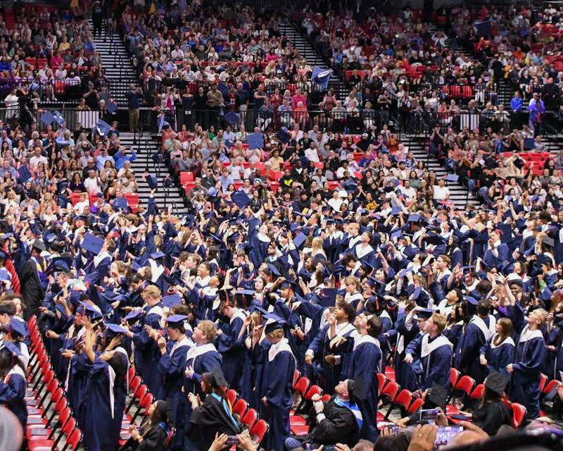Oswego High School seniors toss their caps in the air in celebrations after the graduation ceremony on Saturday May 17, 2025, held at the Convocation Center in DeKalb.