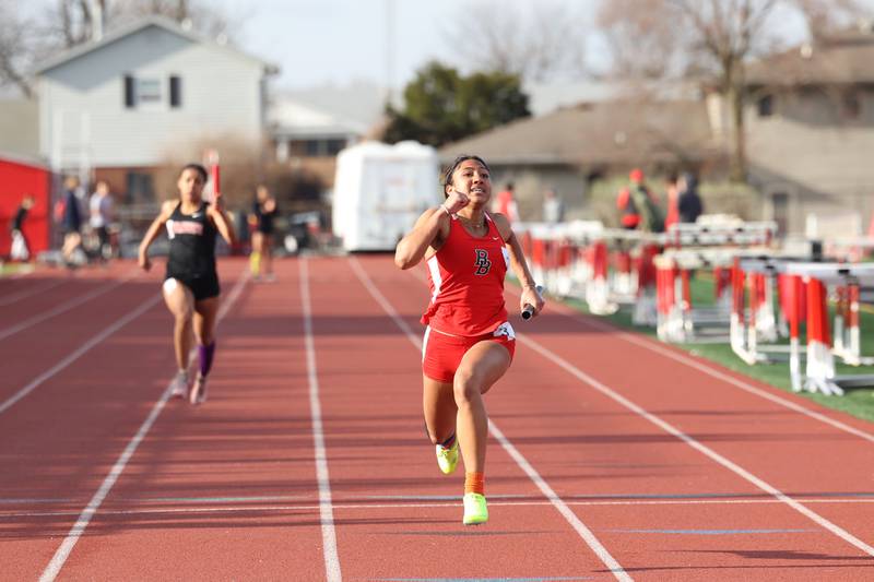 Bradley-Bourbonnais' Niyah Crockett takes first place ahead of Momence's Jaliyah Wright in the 100-meter relay during the Boilermaker Invite on Thursday, April 3, 2025.