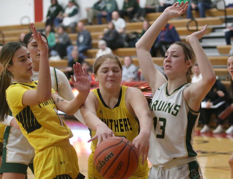 Putnam County's Maggie Spratt (center) looses control of the ball underneath the hoop as St. Bede's Ashlyn Ehm backs away from the play during the Tri-County Conference Tournament championship game on Thursday, Jan. 18, 2024 at Henry-Senachwine High School.