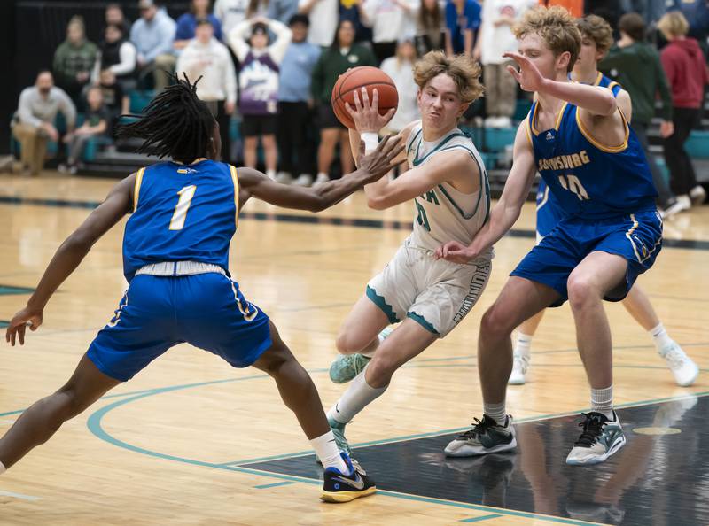 Woodstock North's Trevor Mark, center, is defended by Johnsburg's Jarrel Albea, left, and Ben Person during their game on Wednesday, January 31, 2024 at Woodstock North High School. Ryan Rayburn for Shaw Local