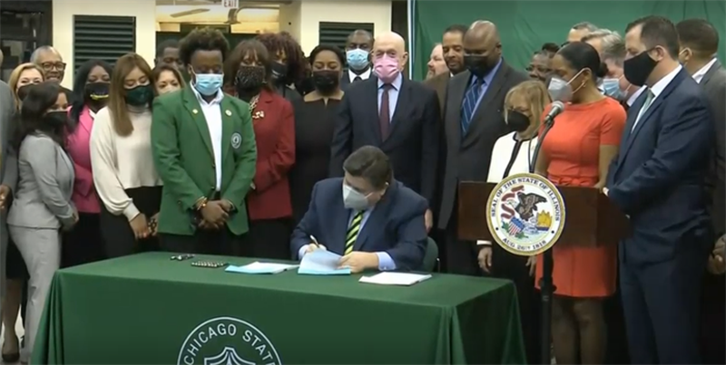 Gov. JB Pritzker signs the state's Fiscal Year 2023 operating budget at Chicago State University Tuesday.