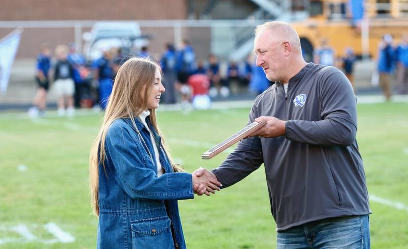 Christy Joehl receives the 2025 Princeton High School Academic and Career Hall of Fame award from principal Andy Berlinski.