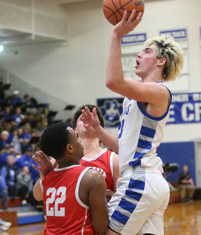 Princeton's Noah LaPorte eyes the hoop over Ottawa's Tristan Finley on Monday, Feb. 5, 2024 at Prouty Gym.