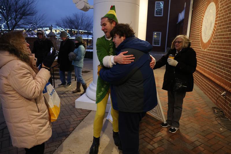 Buddy the Elf hugs Zachary Hojnacki, of Lockport, at New Lenox’s Christmas in the Commons.