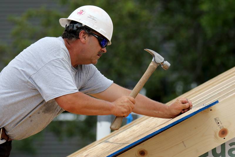 John Lipstreuer, foreman for R & D Thiel CCA Midwest, works on a home in the subdivision of The Oaks at Irish Prairie on Tuesday, June 29, 2021 in McHenry.