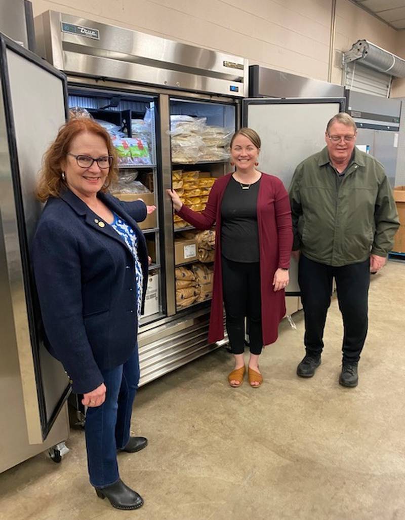 Sycamore Rotary Club President Paulette Renault (left) checks out the new “Big Chill” freezer at the Spartan Food Pantry with pantry manager Courtney Walz and past club president Pat Shafer.