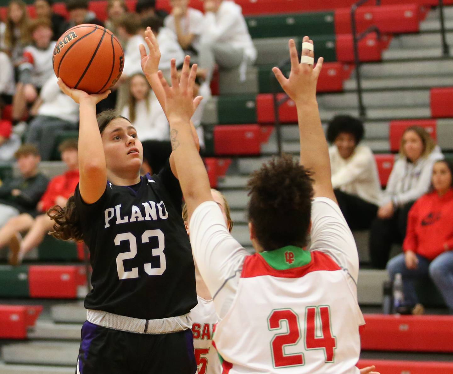 Plano's Josie Larson (23) runs in the lane for a layup as L-P's Jasmine Garman (24) defends on Friday Dec. 2, 2022 in Sellett Gymnasium at La Salle-Peru Township High School