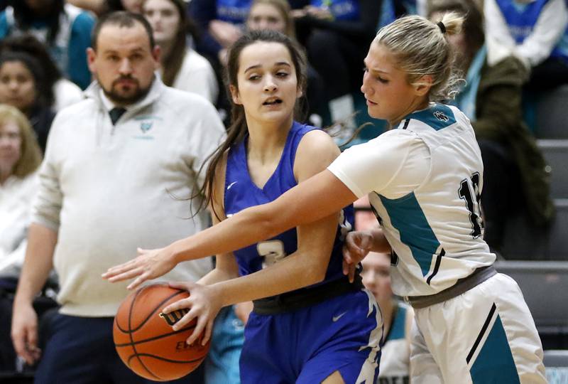 Woodstock Noeth's Addison Rishling tries to steal the ball from Woodstock's Brooklyn Kentgen during a Kishwaukee River Conference girls basketball game on Friday, Jan. 5. 2024, at Woodstock North High School.