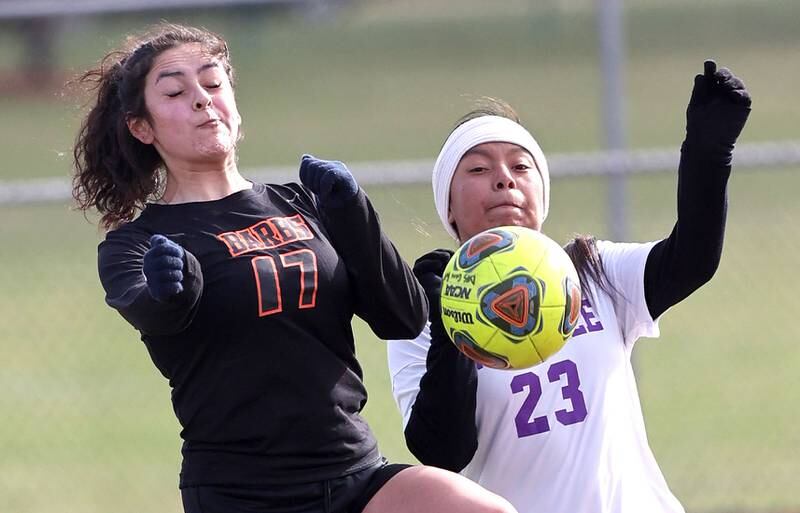 DeKalb's Natalie Delgado and Rochelle's Lucy Monroy try to control the ball during their game Thursday, April 14, 2022, at DeKalb High School.