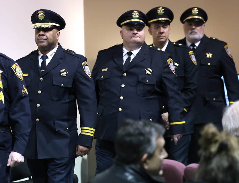 Law enforcement officers walk by after a large group saluted the casket of former DeKalb County Sheriff Roger Scott during a walk-through at his visitation Thursday, March 6, 2025, at Bethany Road Bible Church in DeKalb. Scott, who was the county sheriff for more than 30 years, died on February 23 at the age of 78.