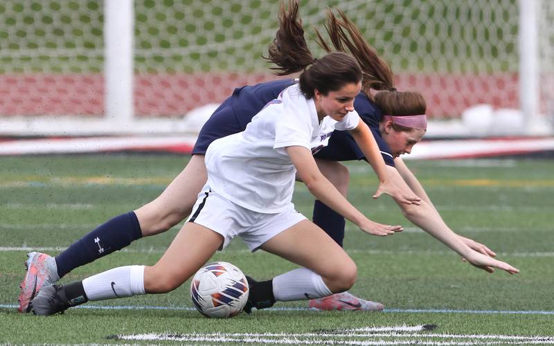 Pleasant Plains' Sophia Taft (front) and IC Catholic Prep's Allie Geiger tumble to the ground going after the ball during the IHSA Class 1A state girls soccer third place game Saturday, May 27, 2023, at North Central College in Naperville.