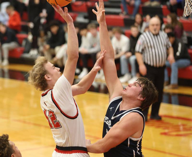 Hall's Hunter Edgcomb gets a shot off over Fieldcrest's Drew Overocker during the Colmone Classic on Friday, Dec. 12, 2025 at Hall High School.