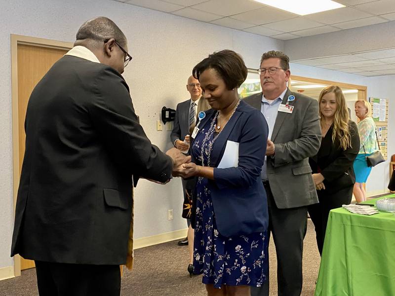 The Rev. Pierre Polycarpe blessed the hands of the health care workers during a dedication ceremony at what was formerly Edward-Elmhurst Health’s Sycamore Family Practice, 954 W. State St. in Sycamore on Tuesday, Oct. 3, 2023. OSF HealthCare recently purchased  the clinic.