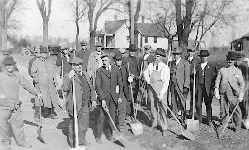 Men with shovels are seen on road grading day, Oct. 26, 1919. The location is unknown.