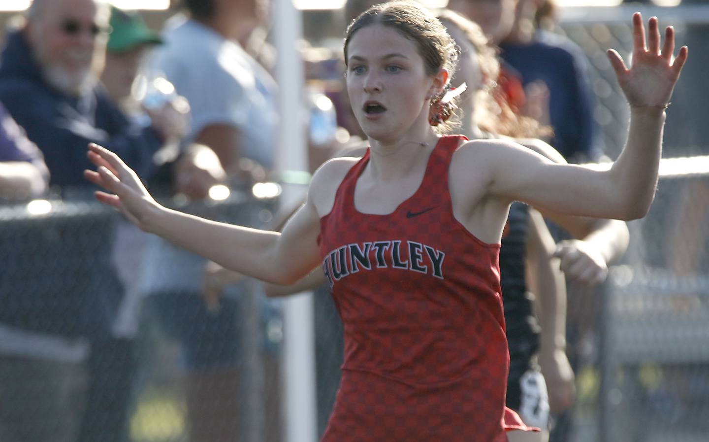 Huntley’s Rachel Hogan reacts to winning the 100 meter dash on Thursday, April 23, 2026, during the McHenry County Track and Field Meet at McCracken Field in McHenry.